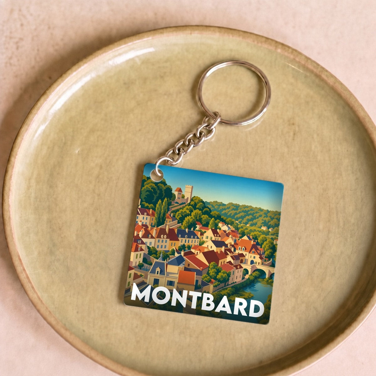 Porte-clés souvenir de la ville de Montbard avec une illustration stylisée.