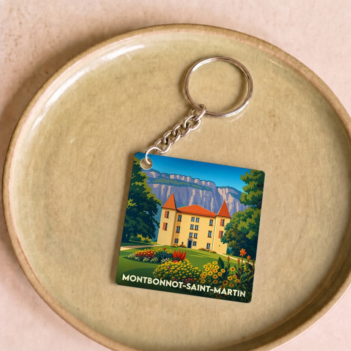 Porte-clés souvenir de la ville de Montbonnot-Saint-Martin avec une illustration stylisée.