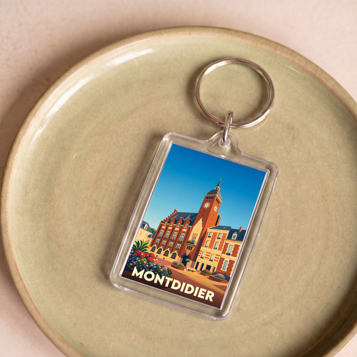 Porte-clés souvenir de la ville de Montdidier avec une illustration stylisée de son hôtel de ville.