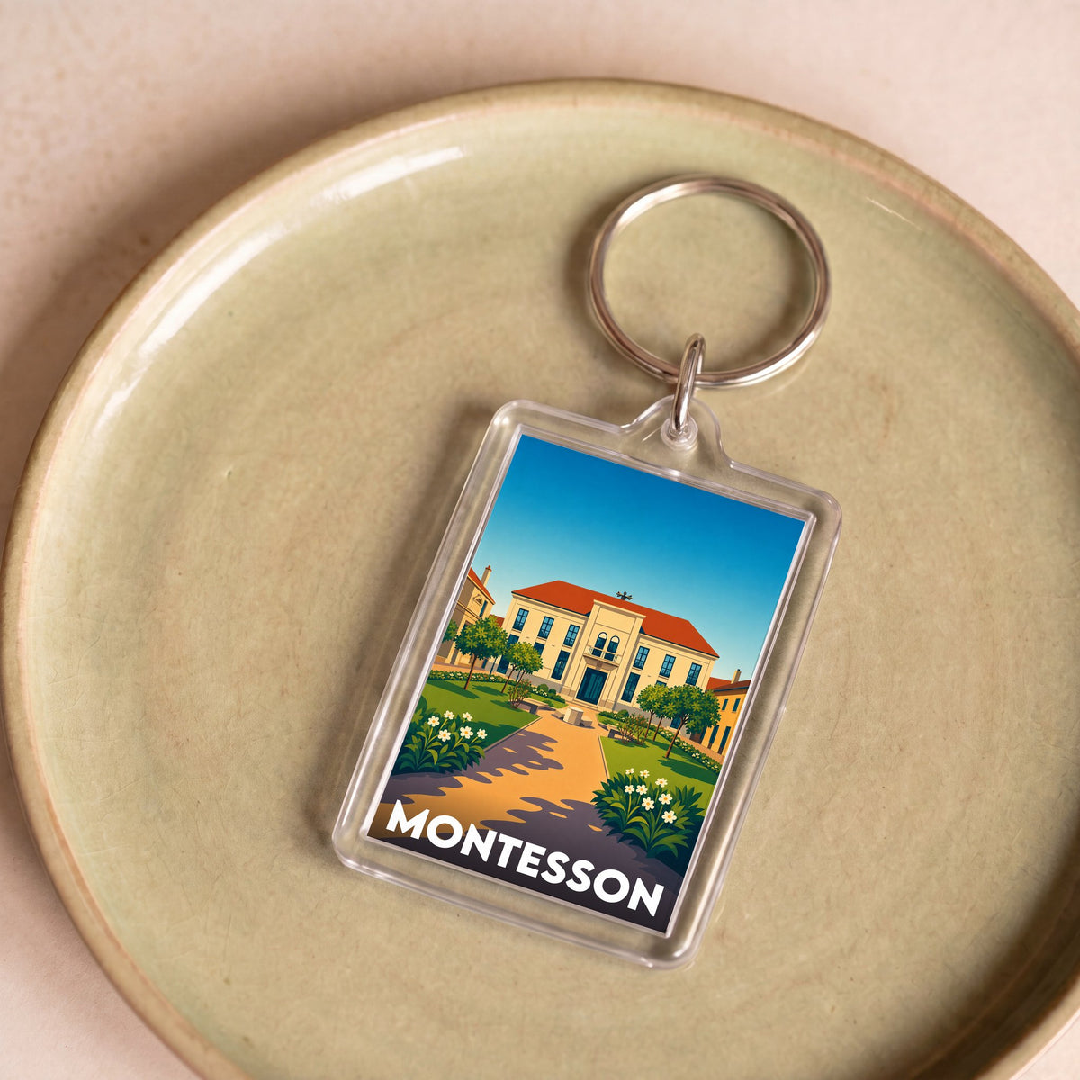 Porte-clés souvenir de la ville de Montesson avec une illustration stylisée.