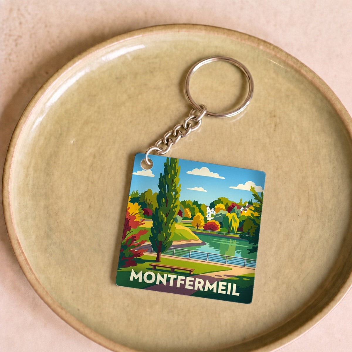 Porte-clés souvenir de la ville de Montfermeil avec une illustration stylisée.