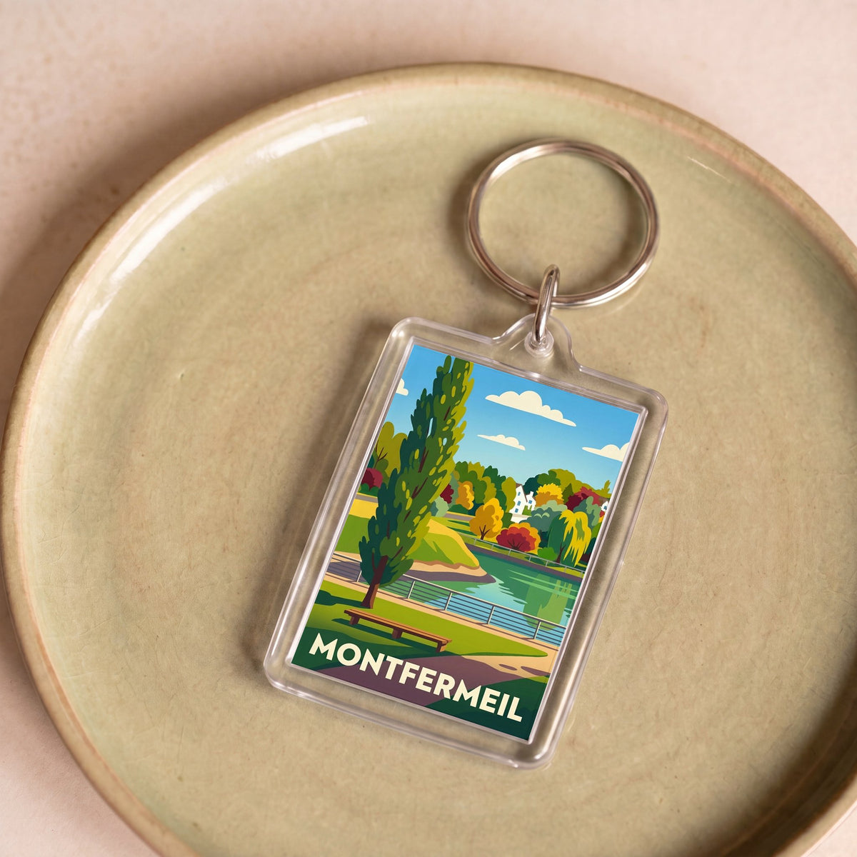 Porte-clés souvenir de la ville de Montfermeil avec une illustration stylisée.