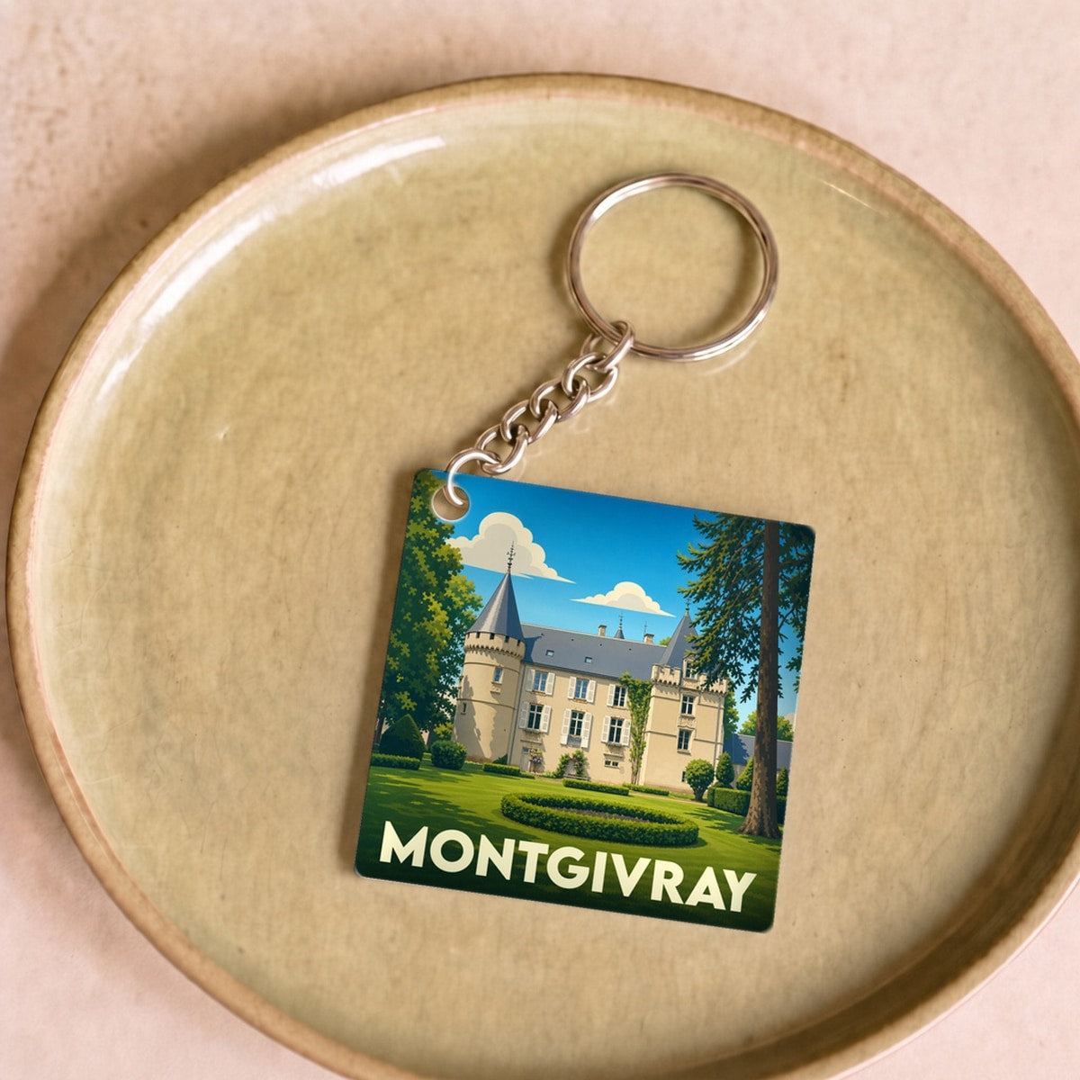 Porte-clés souvenir de la ville de Montgivray avec une illustration stylisée de son château.