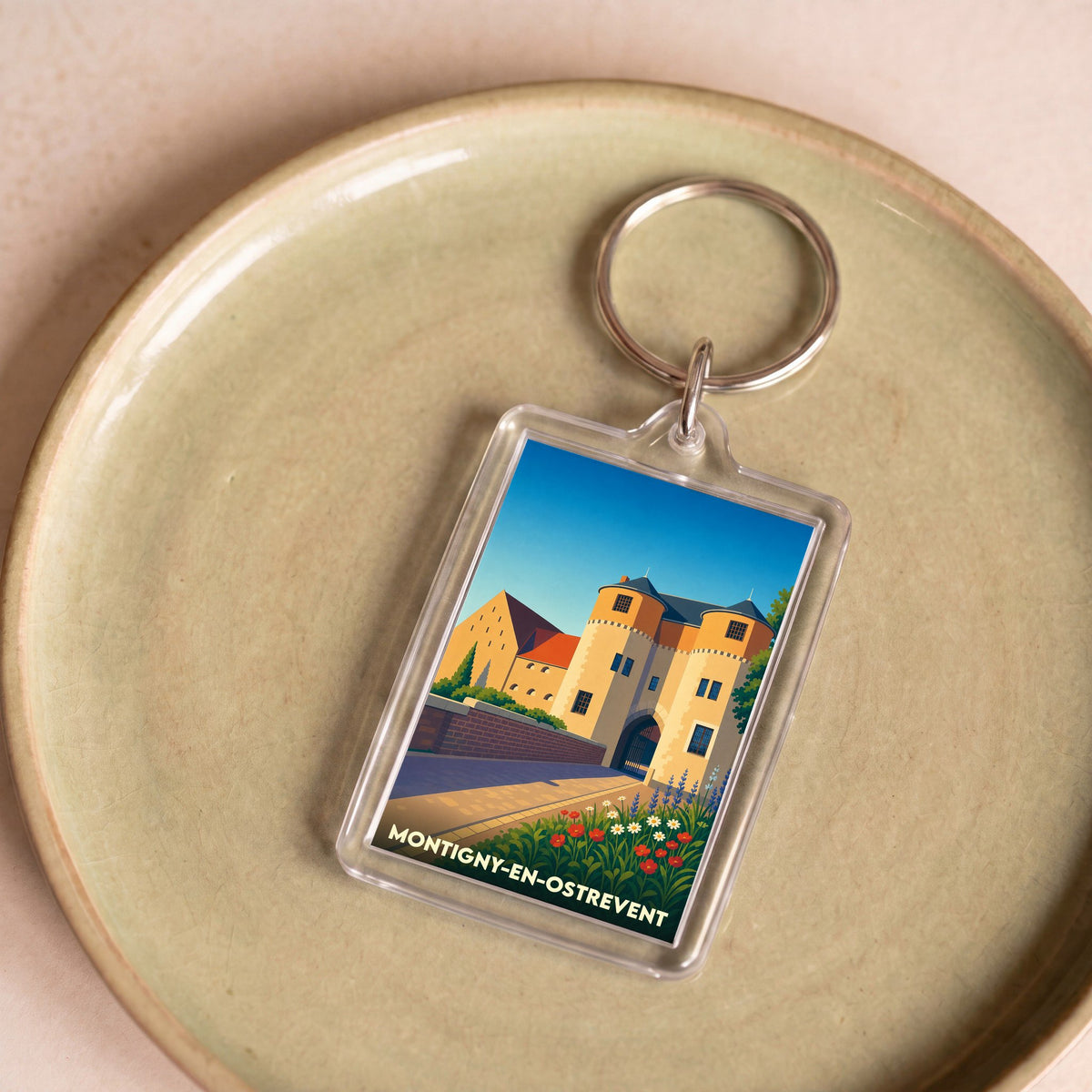 Porte-clés souvenir de la ville de Montigny-en-Ostrevent avec une illustration stylisée de son château.