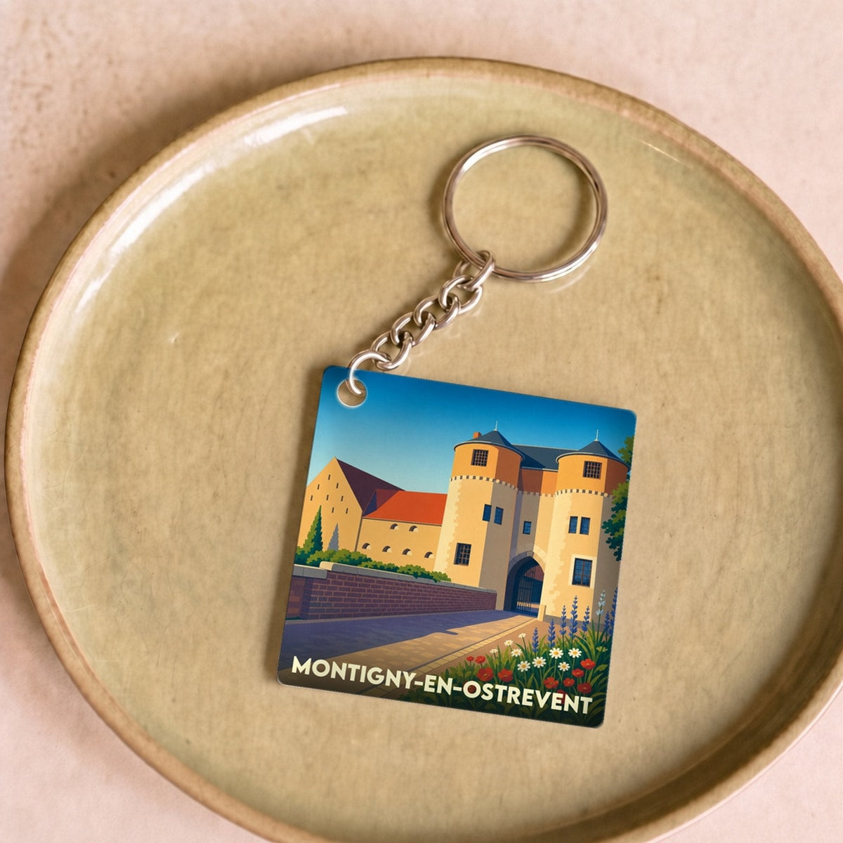 Porte-clés souvenir de la ville de Montigny-en-Ostrevent avec une illustration stylisée de son château.