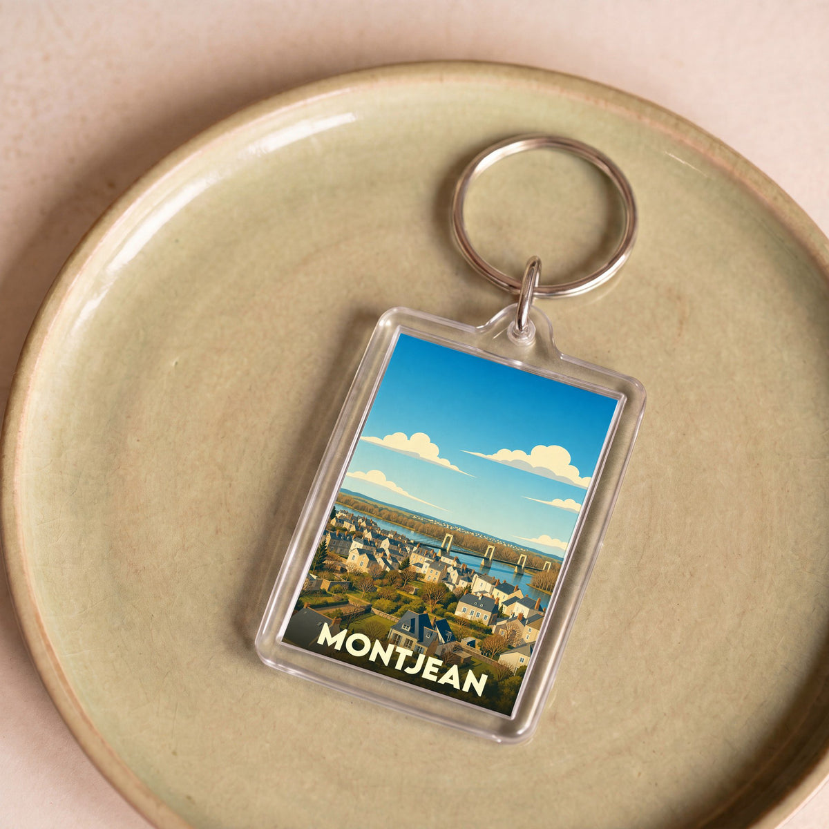 Porte-clés souvenir de la ville de Montjean avec une illustration stylisée.