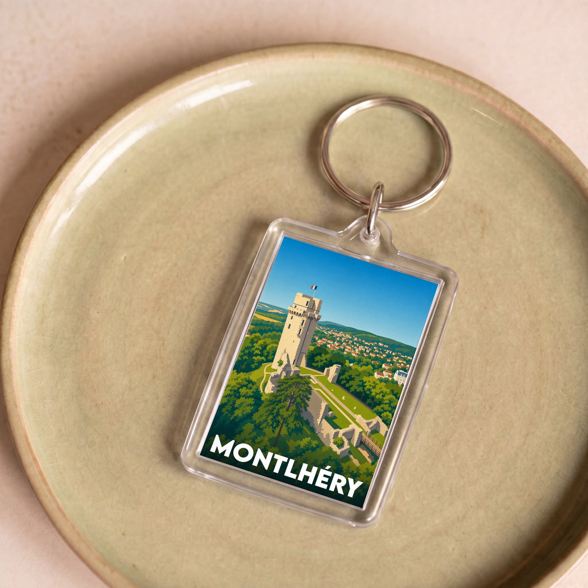 Porte-clés souvenir de la ville de Montlhéry avec une illustration stylisée de sa tour médiévale.