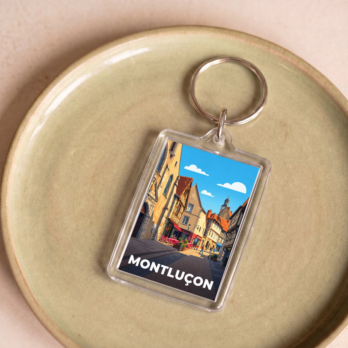 Porte-clés souvenir de la ville de Montluçon avec une illustration stylisée.