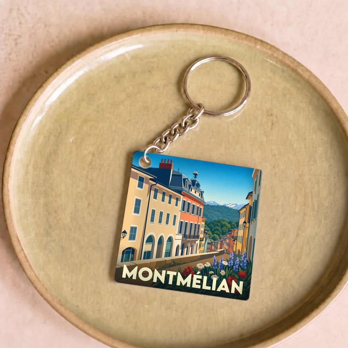 Porte-clés souvenir de la ville de Montmélian avec une illustration stylisée.