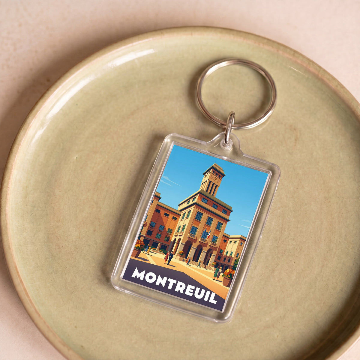 Porte-clés souvenir de la ville de Montreuil avec une illustration stylisée.