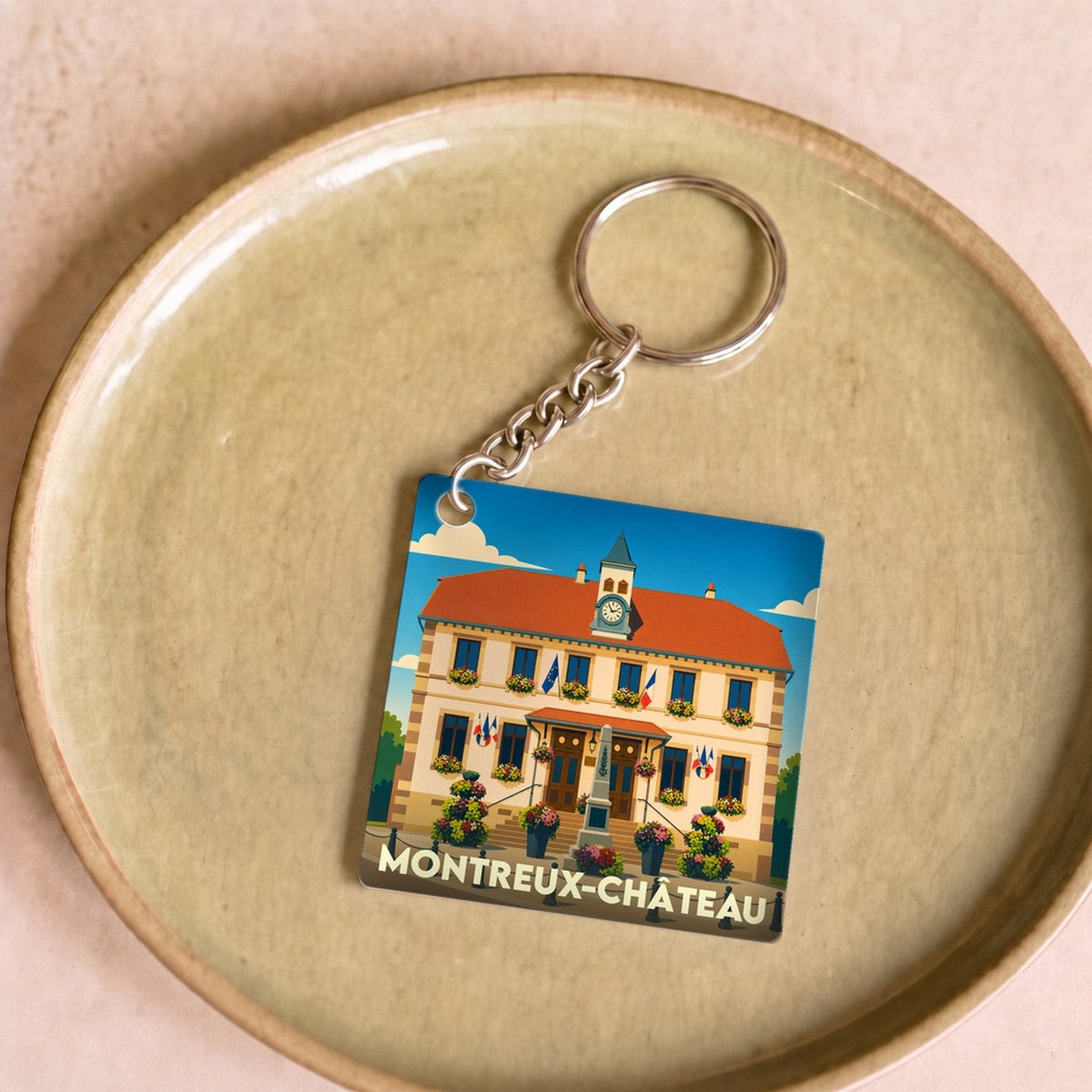 Porte-clés souvenir de la ville de Montreux-Château avec une illustration stylisée de sa mairie.