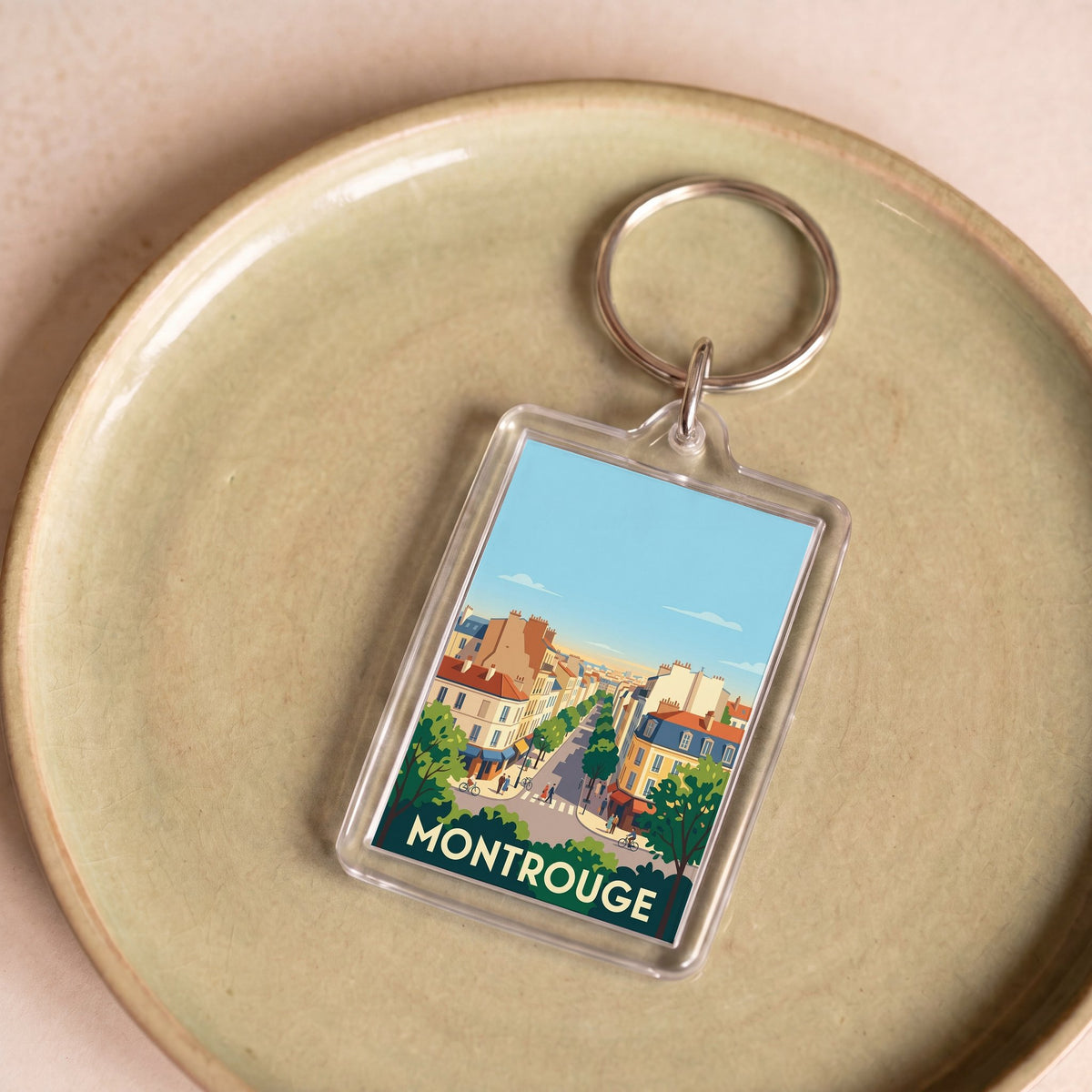 Porte-clés souvenir de la ville de Montrouge avec une illustration stylisée.