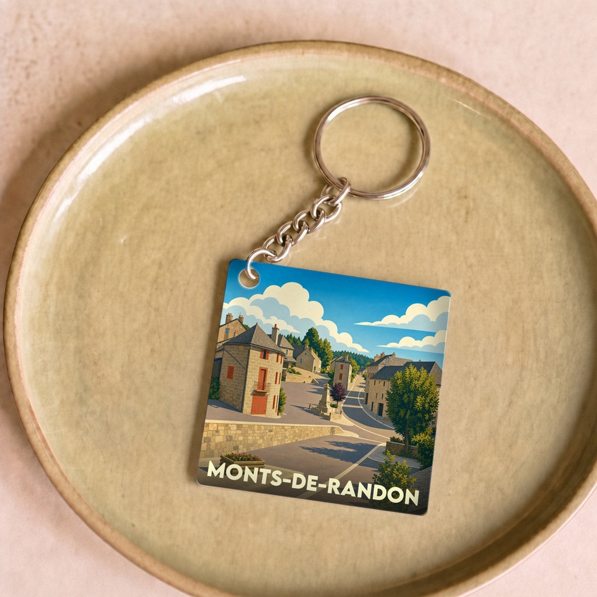 Porte-clés souvenir de la ville de Monts-de-Randon avec une illustration stylisée.