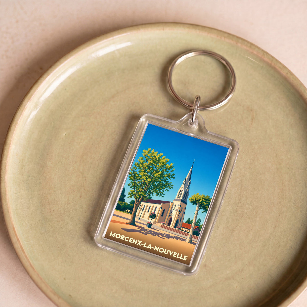 Porte-clés souvenir de la ville de Morcenx-la-Nouvelle avec une illustration stylisée de son église.