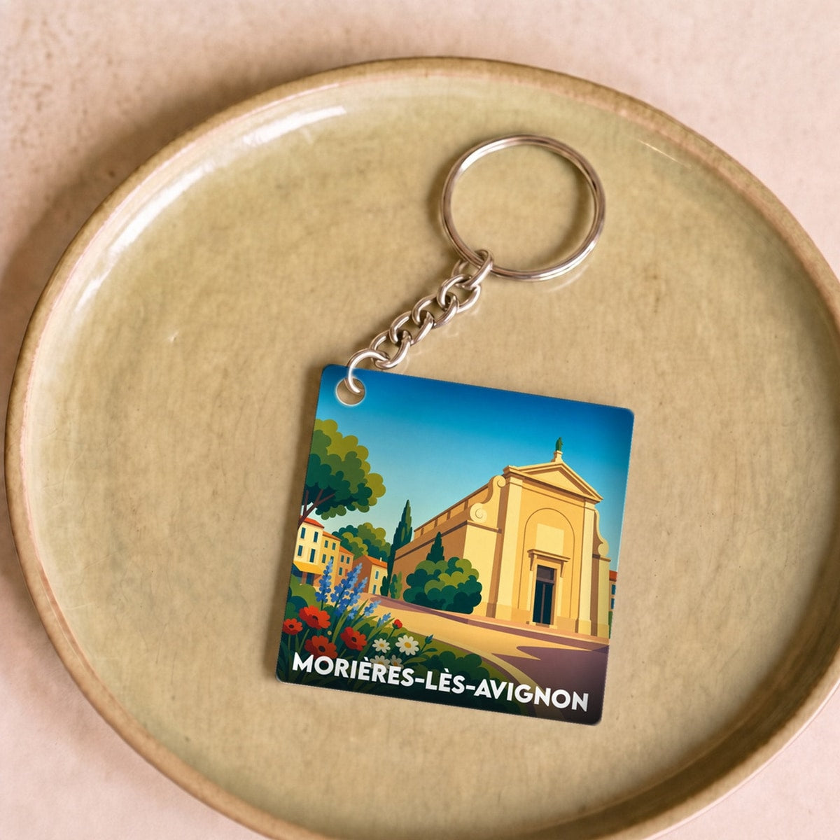 Porte-clés souvenir de la ville de Morières-lès-Avignon avec une illustration stylisée.