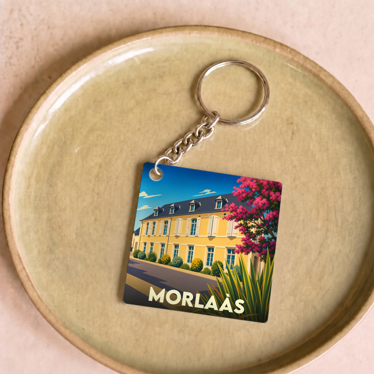 Porte-clés souvenir de la ville de Morlaàs avec une illustration stylisée.