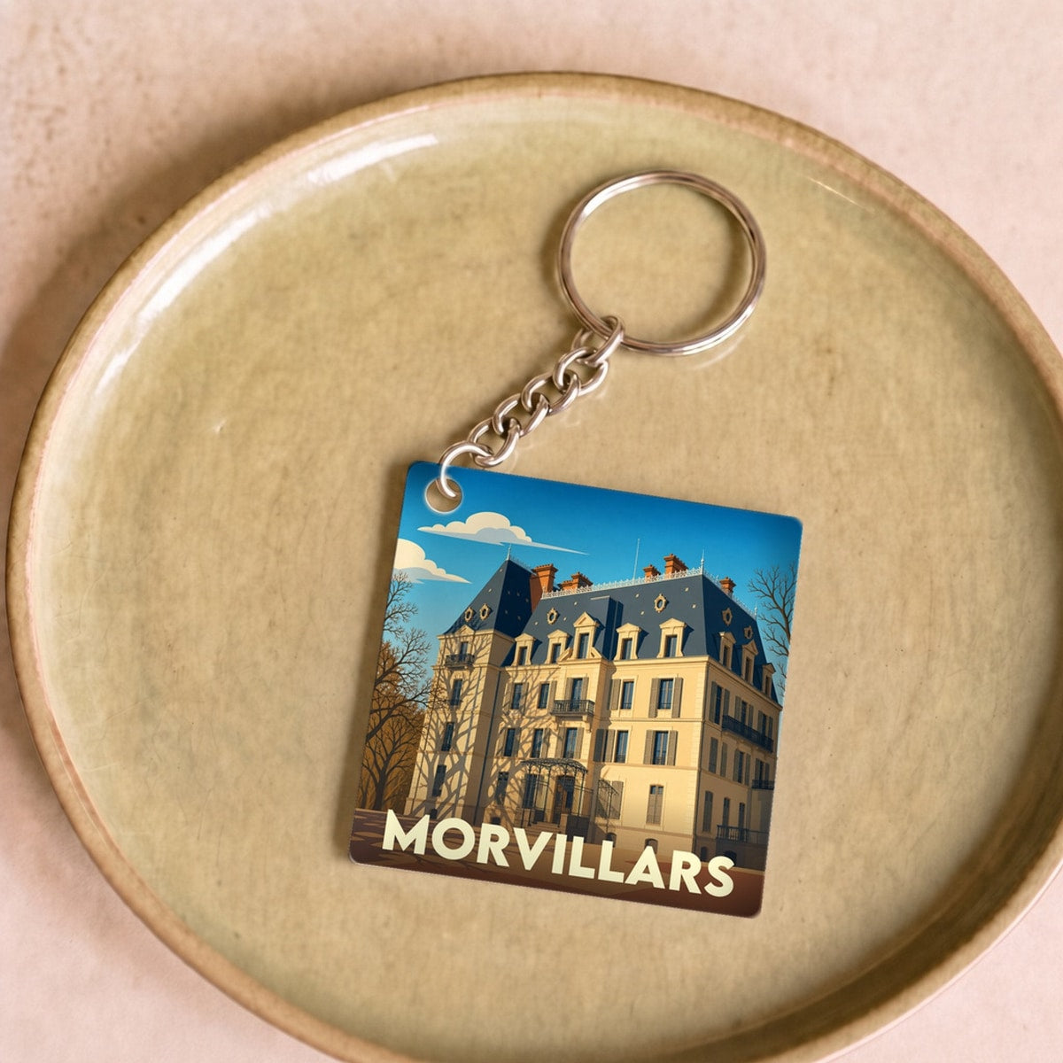 Porte-clés souvenir de la ville de Morvillars avec une illustration stylisée d'un château.
