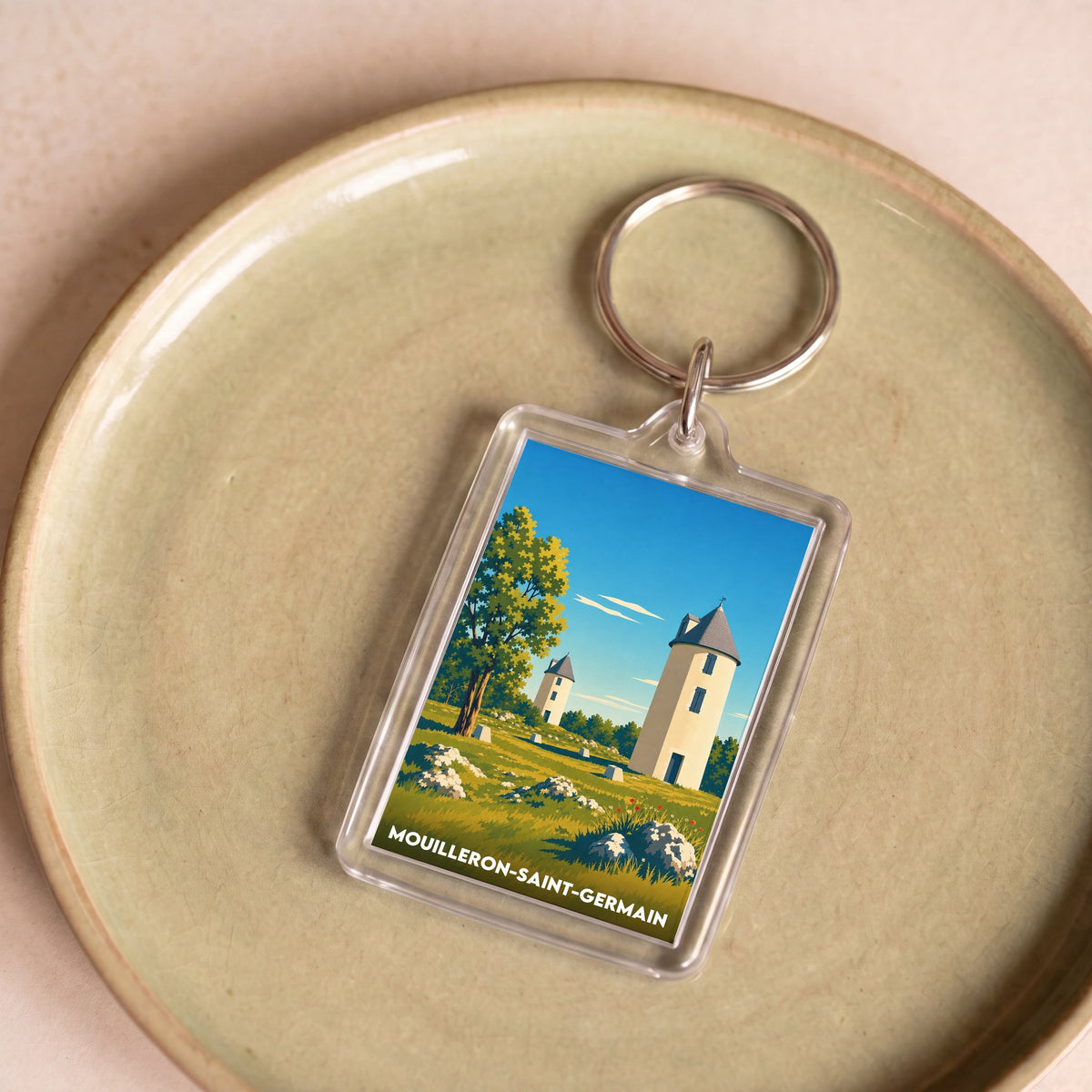 Porte-clés souvenir de la ville de Mouilleron-Saint-Germain avec une illustration stylisée.