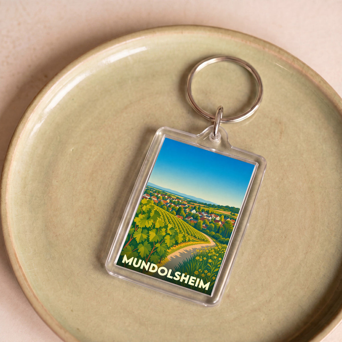 Porte-clés souvenir de la ville de Mundolsheim arborant une illustration stylisée de ses paysages de vignobles.