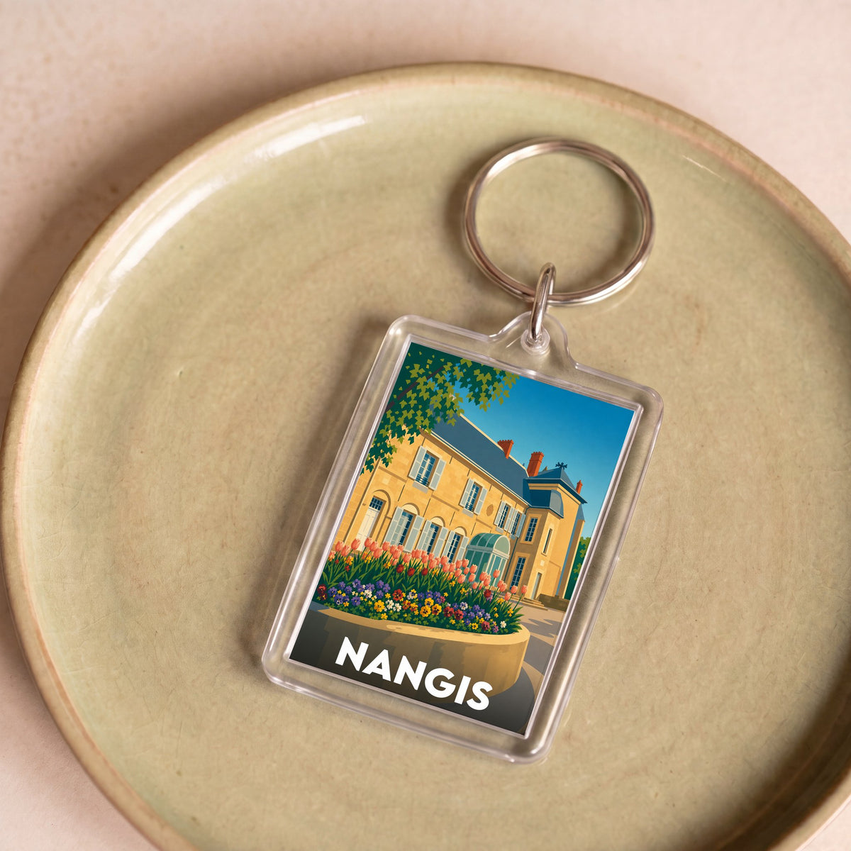 Porte-clés souvenir de la ville de Nangis avec une illustration stylisée.