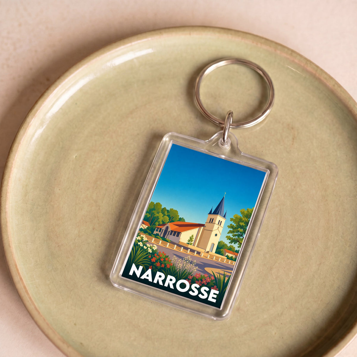 Porte-clés souvenir de la ville de Narrosse avec une illustration stylisée.
