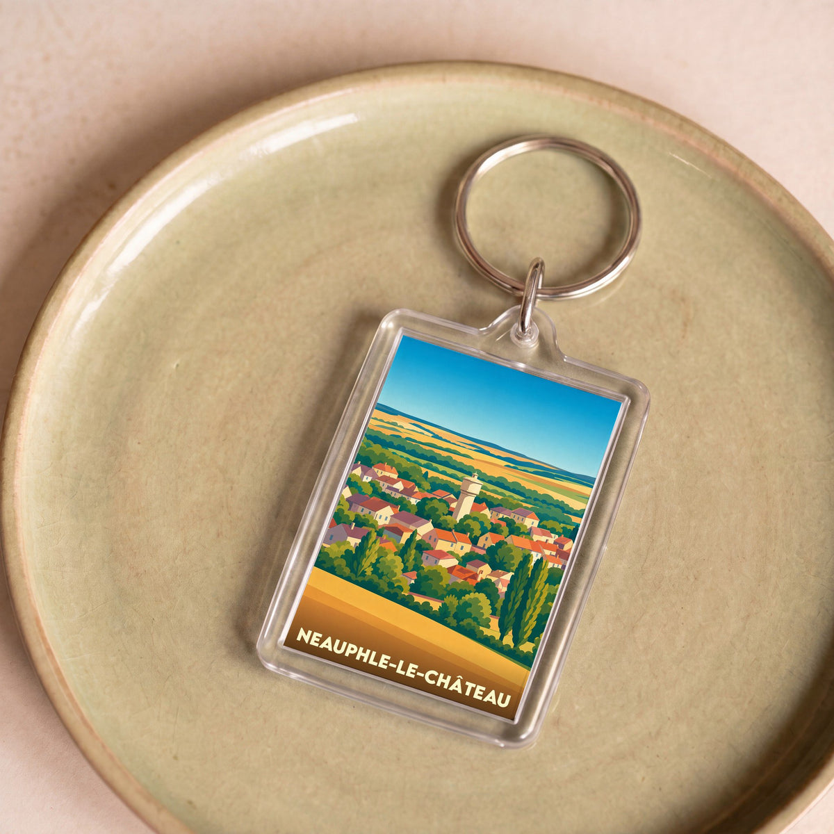 Porte-clés souvenir de la ville de Neauphle-le-Château avec une illustration stylisée.