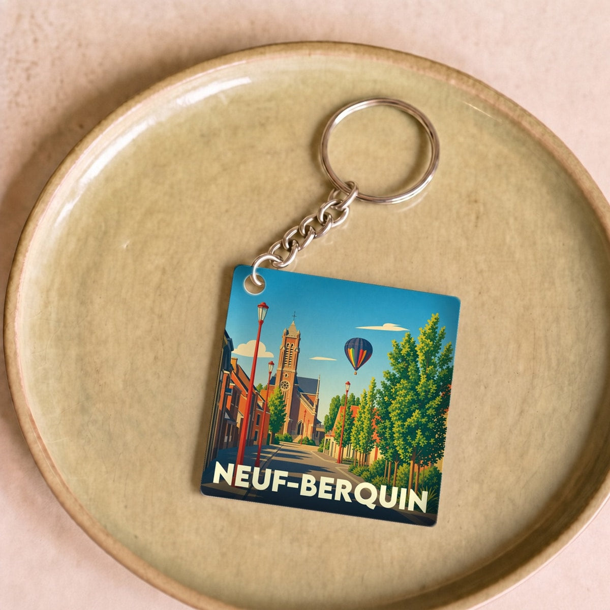 Porte-clés souvenir de la ville de Neuf-Berquin avec une illustration colorée et stylisée.