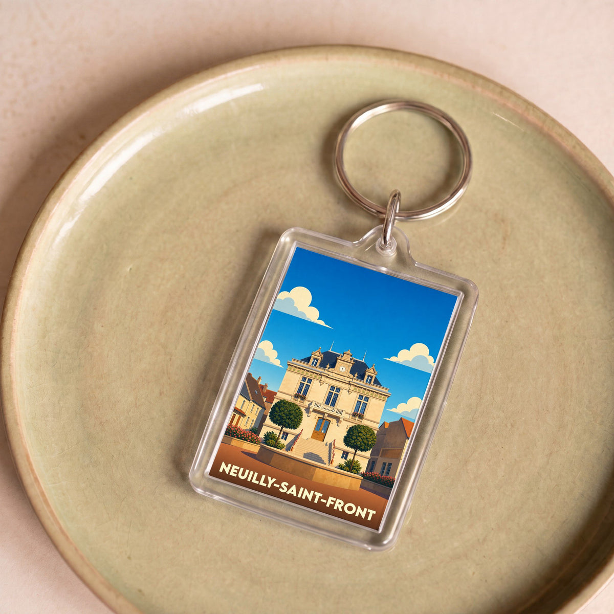 Porte-clés souvenir de la ville de Neuilly-Saint-Front avec une illustration stylisée de sa mairie.