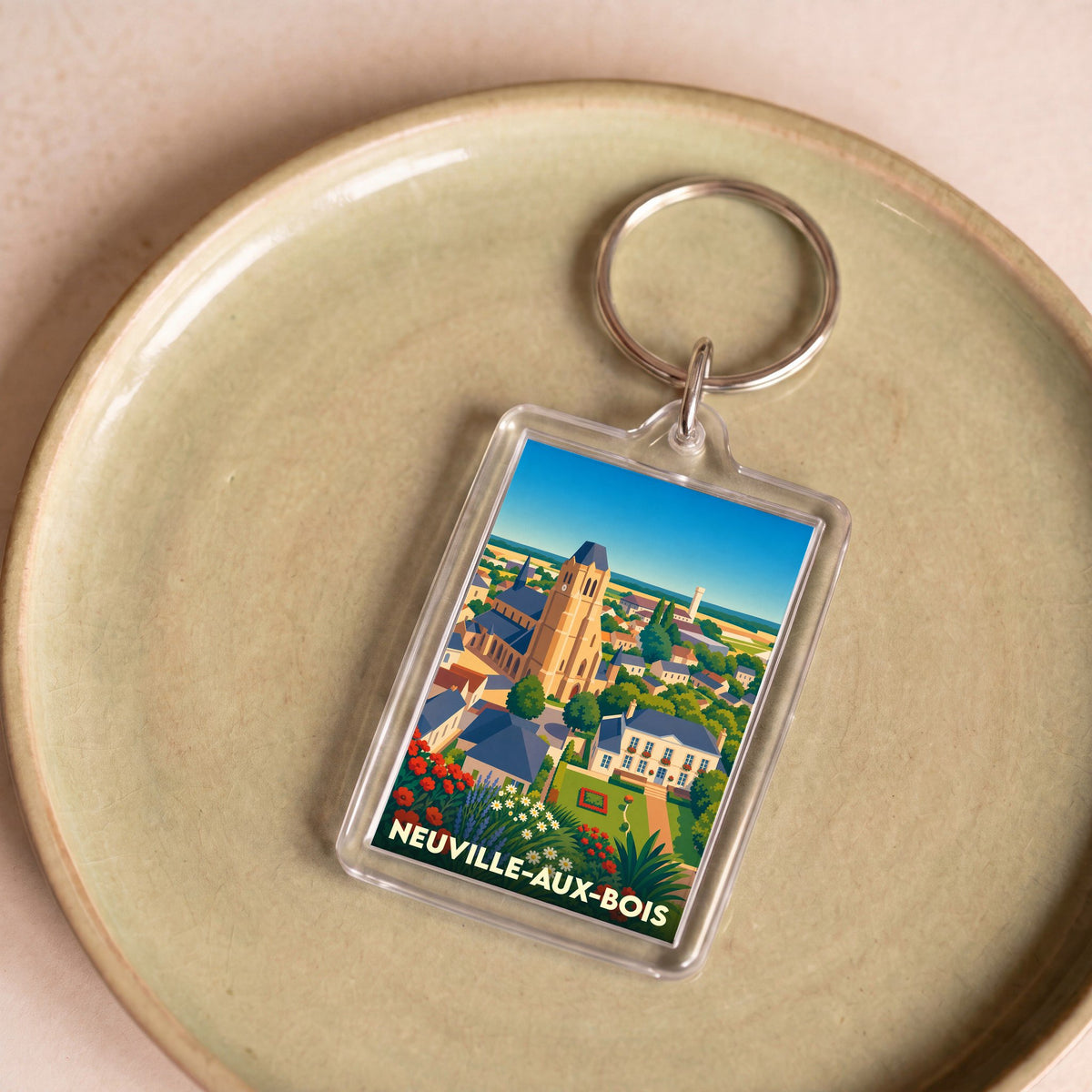 Porte-clés souvenir de la ville de Neuville-aux-Bois avec une illustration stylisée.