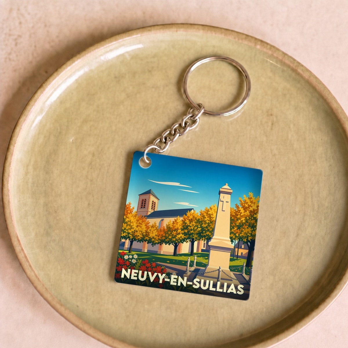 Porte-clés souvenir de la ville de Neuvy-en-Sullias avec une illustration stylisée.
