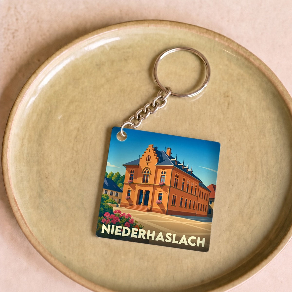 Porte-clés souvenir de la ville de Niederhaslach avec une illustration stylisée.