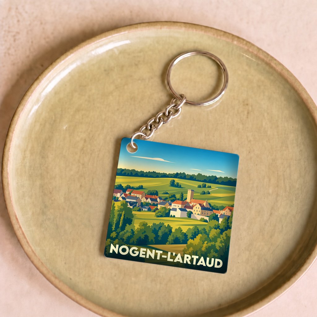 Porte-clés souvenir de la ville de Nogent-l'Artaud avec une illustration stylisée d'un paysage de campagne.