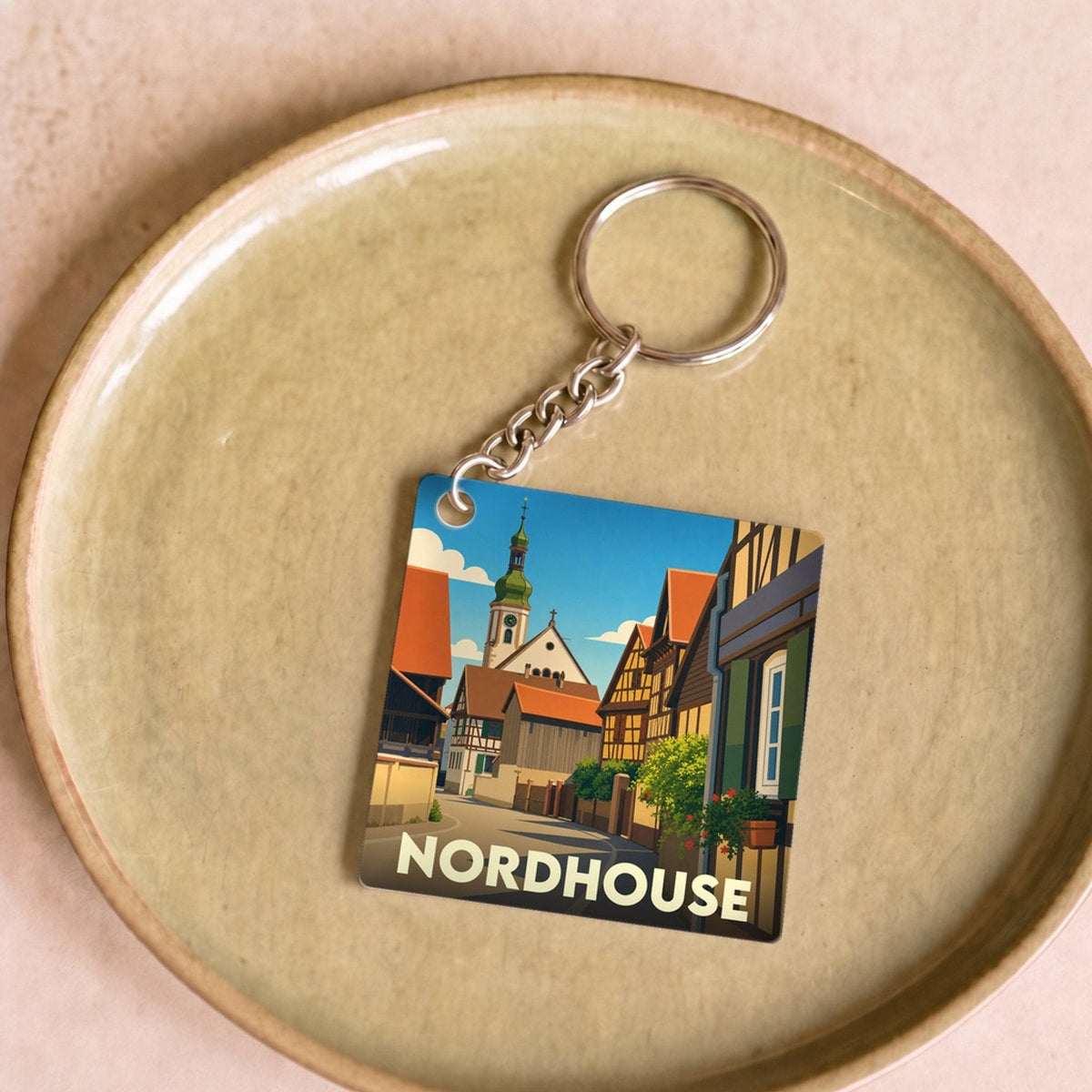 Porte-clés souvenir de la ville de Nordhouse avec une illustration stylisée.