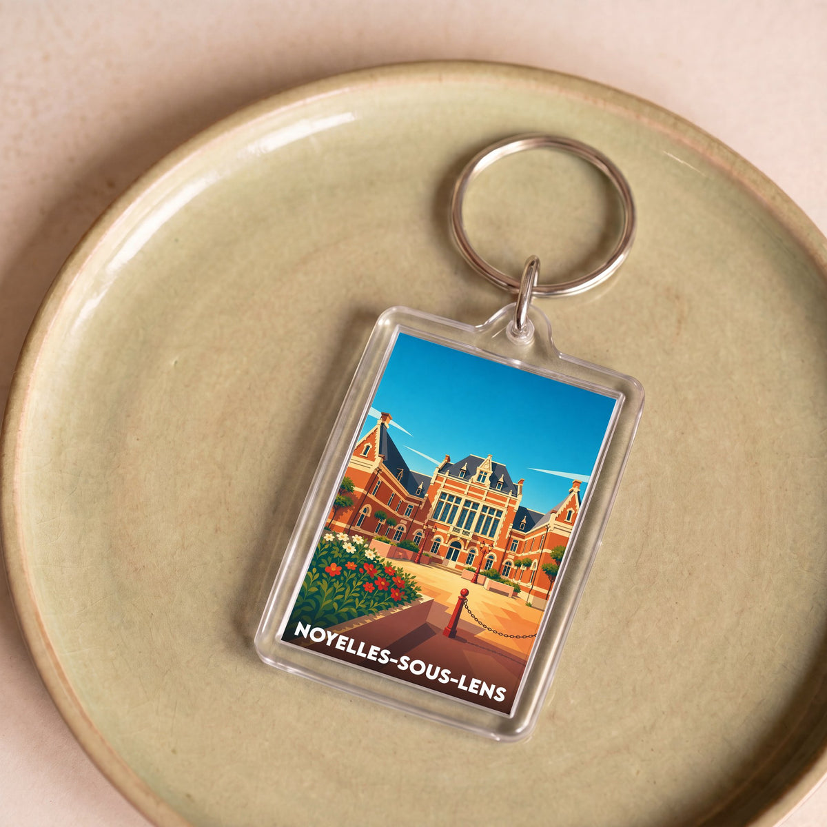 Porte-clés souvenir de la ville de Noyelles-sous-Lens avec une illustration stylisée de son patrimoine.