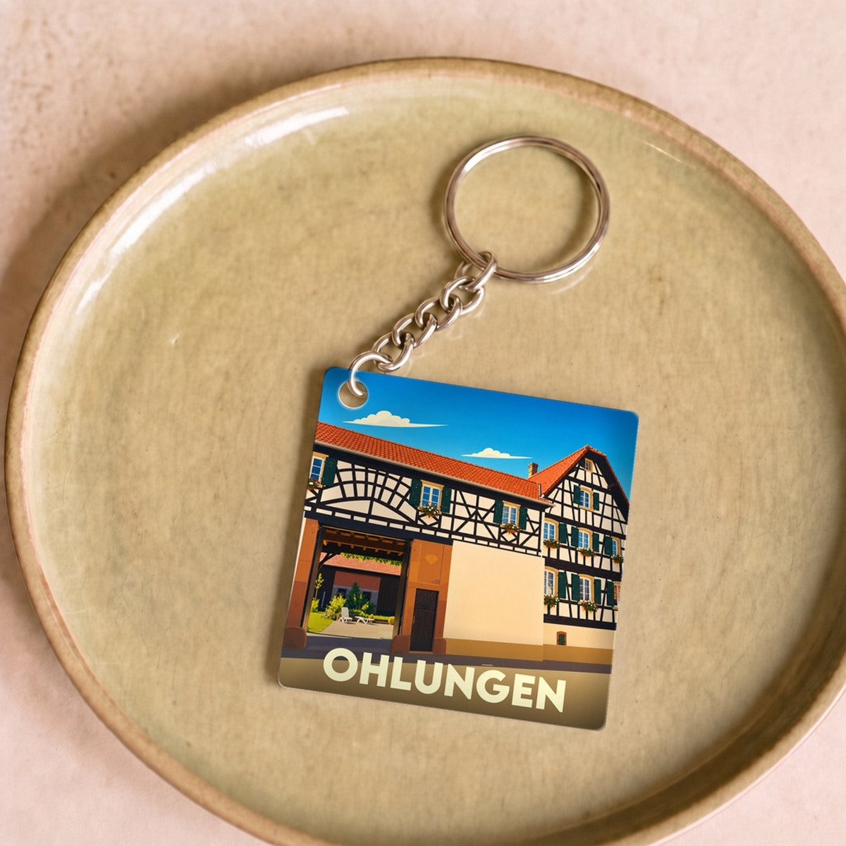 Porte-clés souvenir de la ville de Ohlungen avec une illustration stylisée d'une maison à colombages.