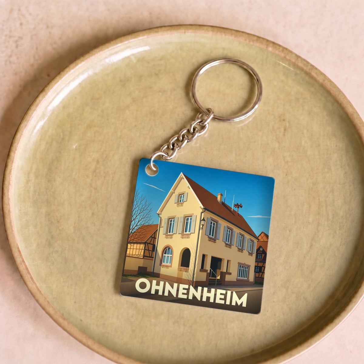 Porte-clés souvenir de la ville de Ohnenheim avec une illustration stylisée.