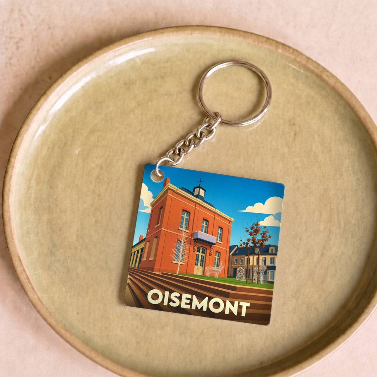 Porte-clés souvenir de la ville de Oisemont avec une illustration colorée et stylisée.