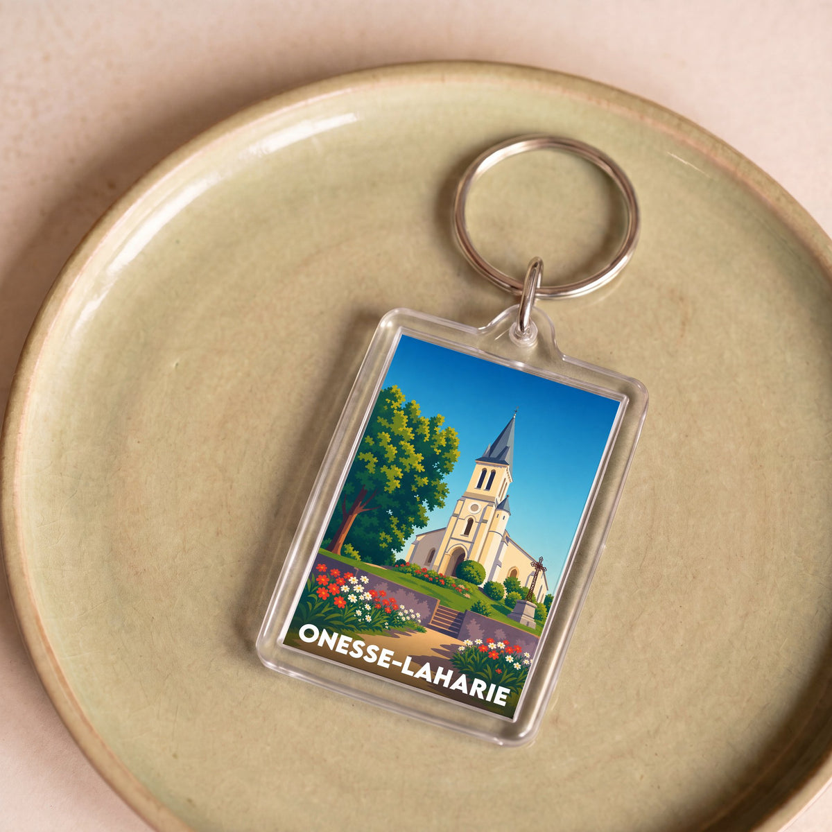 Porte-clés souvenir de la ville de Onesse-Laharie avec une illustration stylisée.
