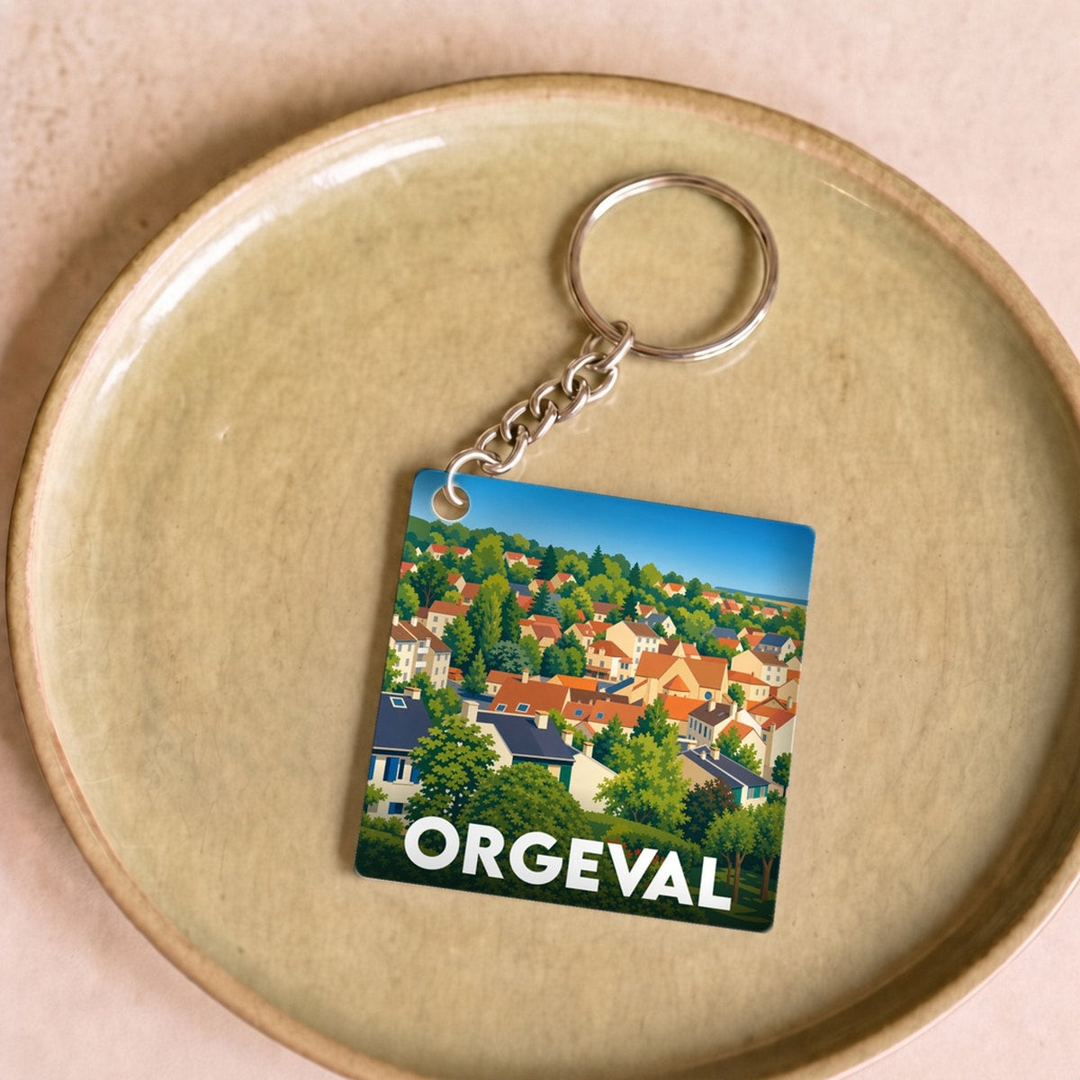 Porte-clés souvenir de la ville de Orgeval avec une illustration stylisée d'un paysage urbain.