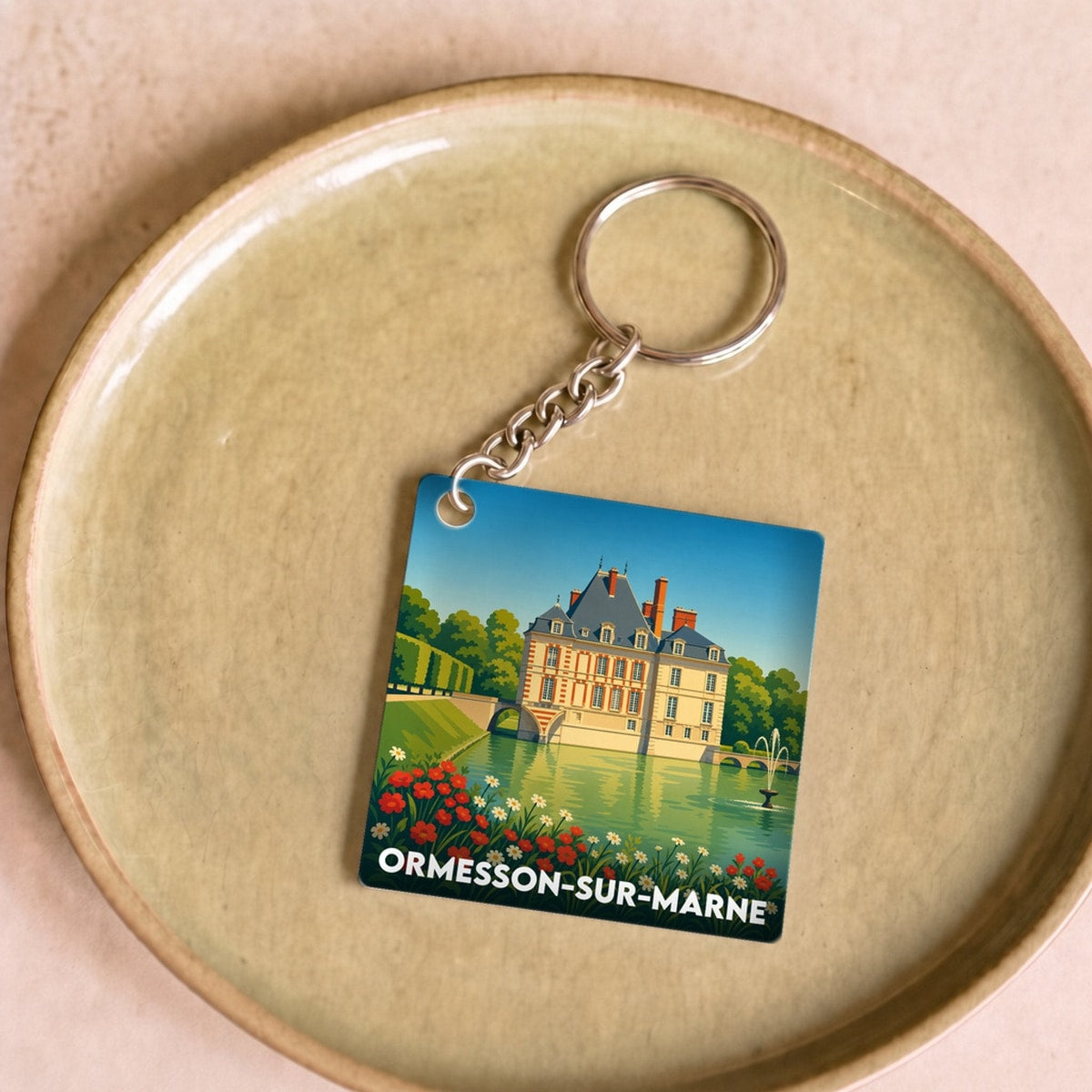 Porte-clés souvenir de la ville d'Ormesson-sur-Marne avec une illustration stylisée de son château.