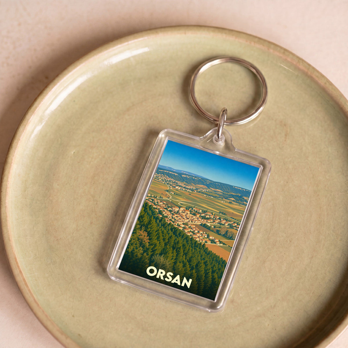 Porte-clés souvenir de la ville de Orsan avec une illustration stylisée.