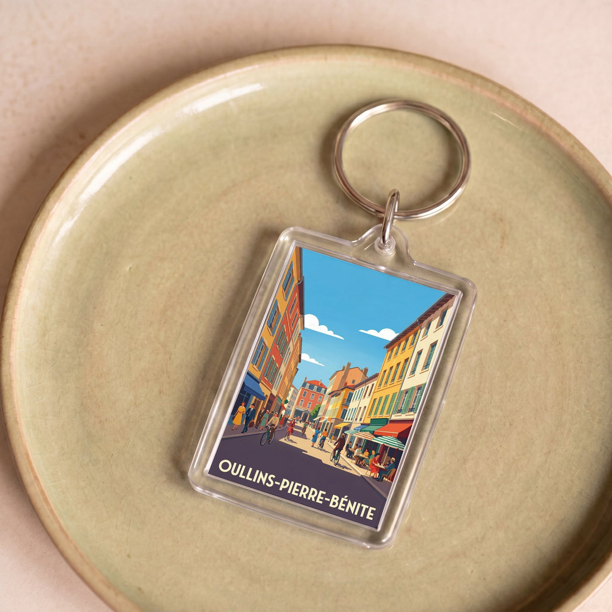 Porte-clés souvenir de la ville d'Oullins-Pierre-Bénite avec une illustration graphique colorée.