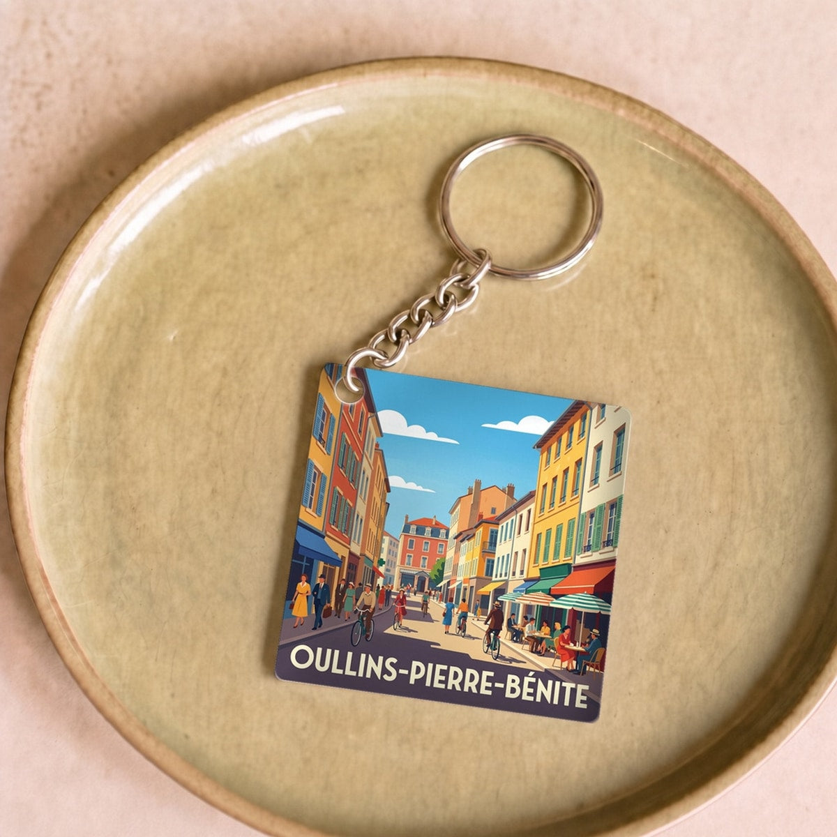 Porte-clés souvenir de la ville d'Oullins-Pierre-Bénite avec une illustration graphique colorée.