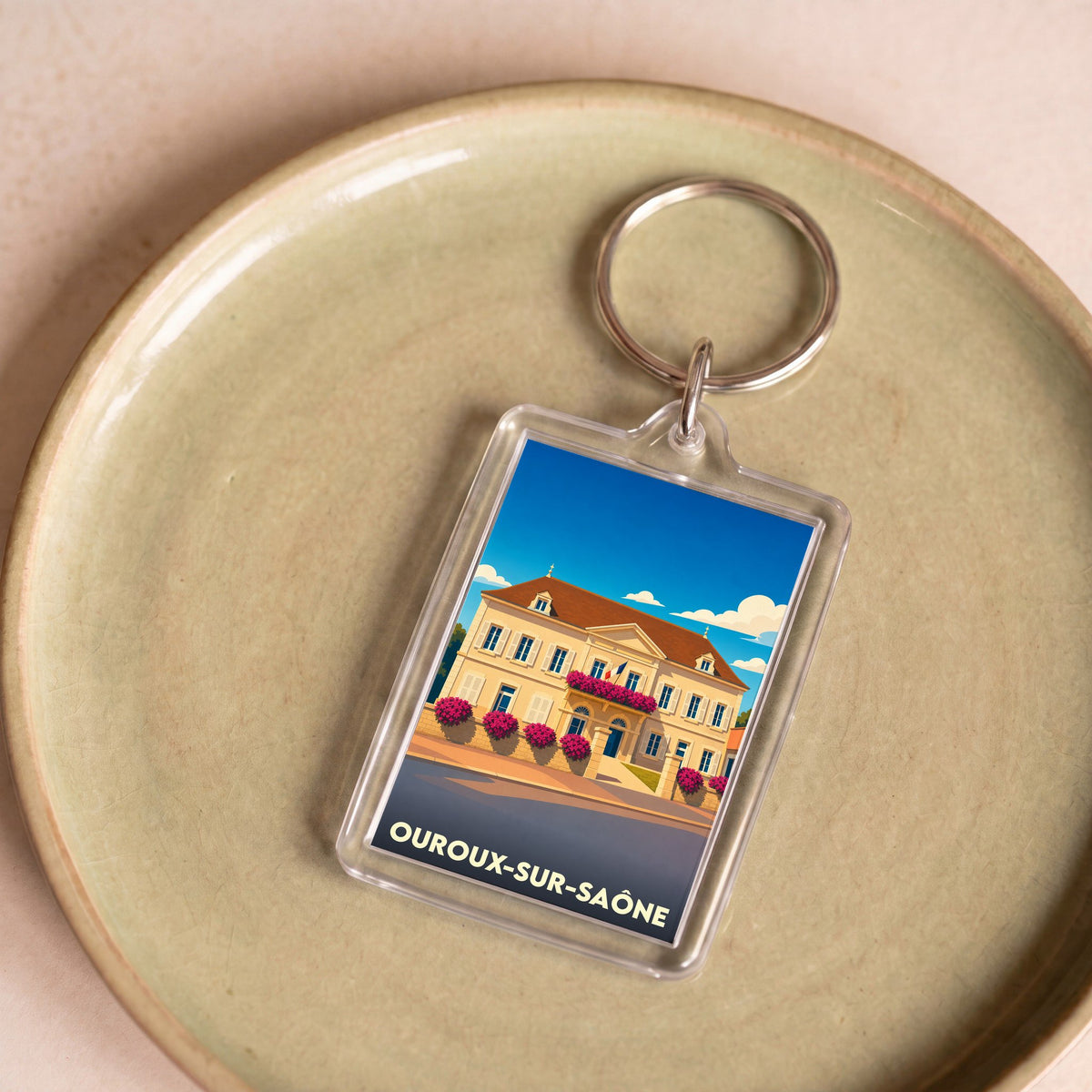 Porte-clés souvenir de la ville de Ouroux-sur-Saône avec une illustration stylisée de sa mairie.