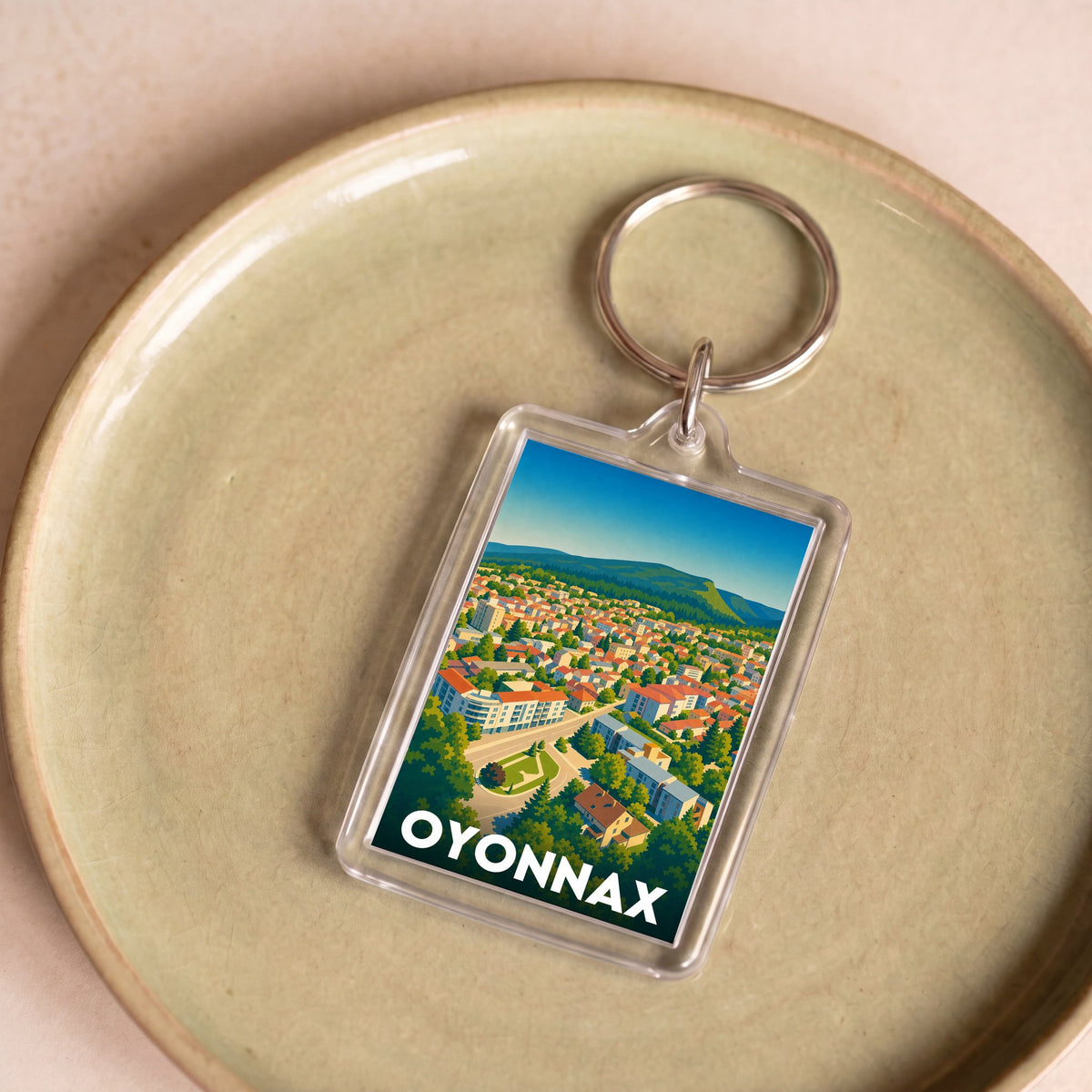 Porte-clés souvenir de la ville d'Oyonnax avec une illustration stylisée.