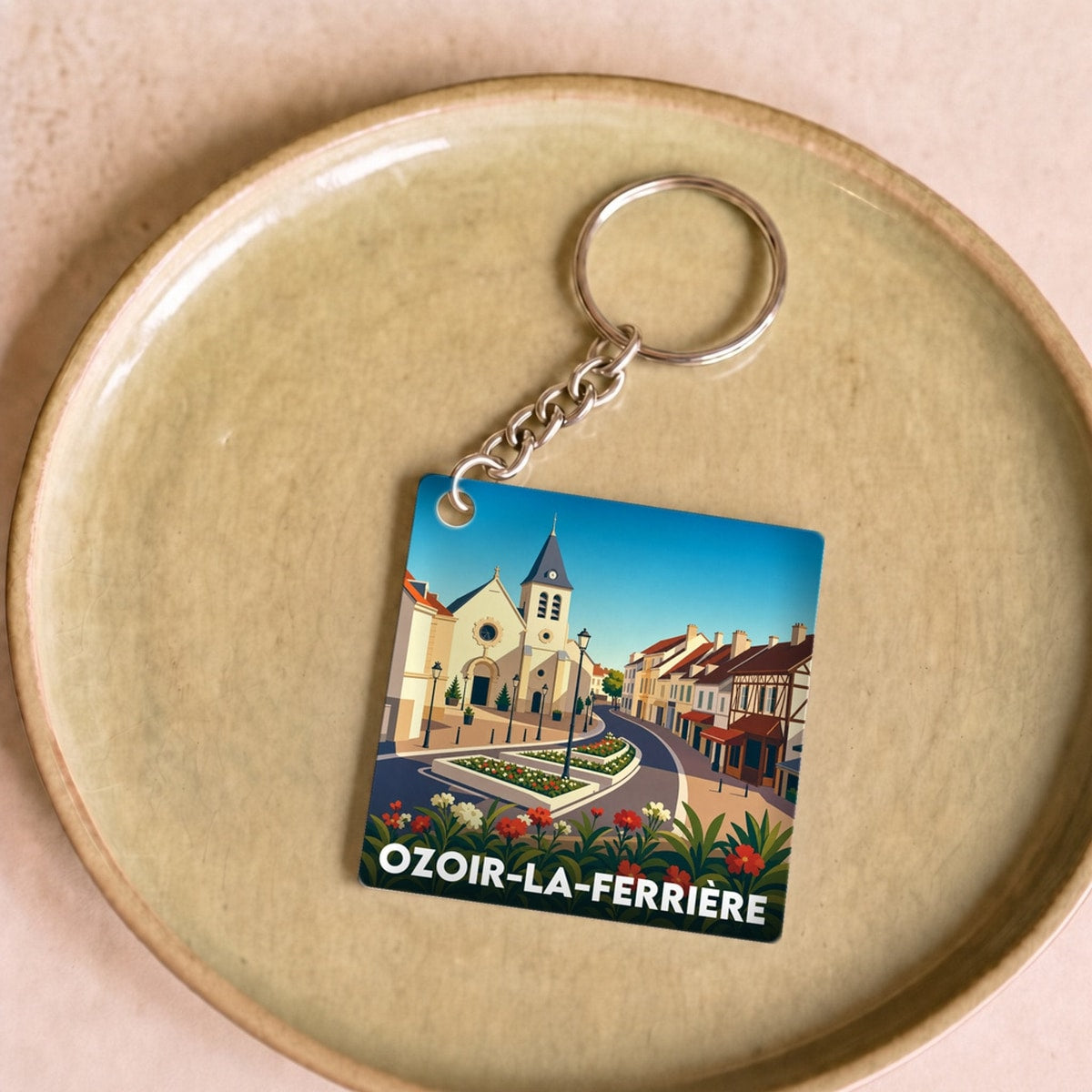 Porte-clés souvenir de la ville d'Ozoir-la-Ferrière avec une illustration stylisée.