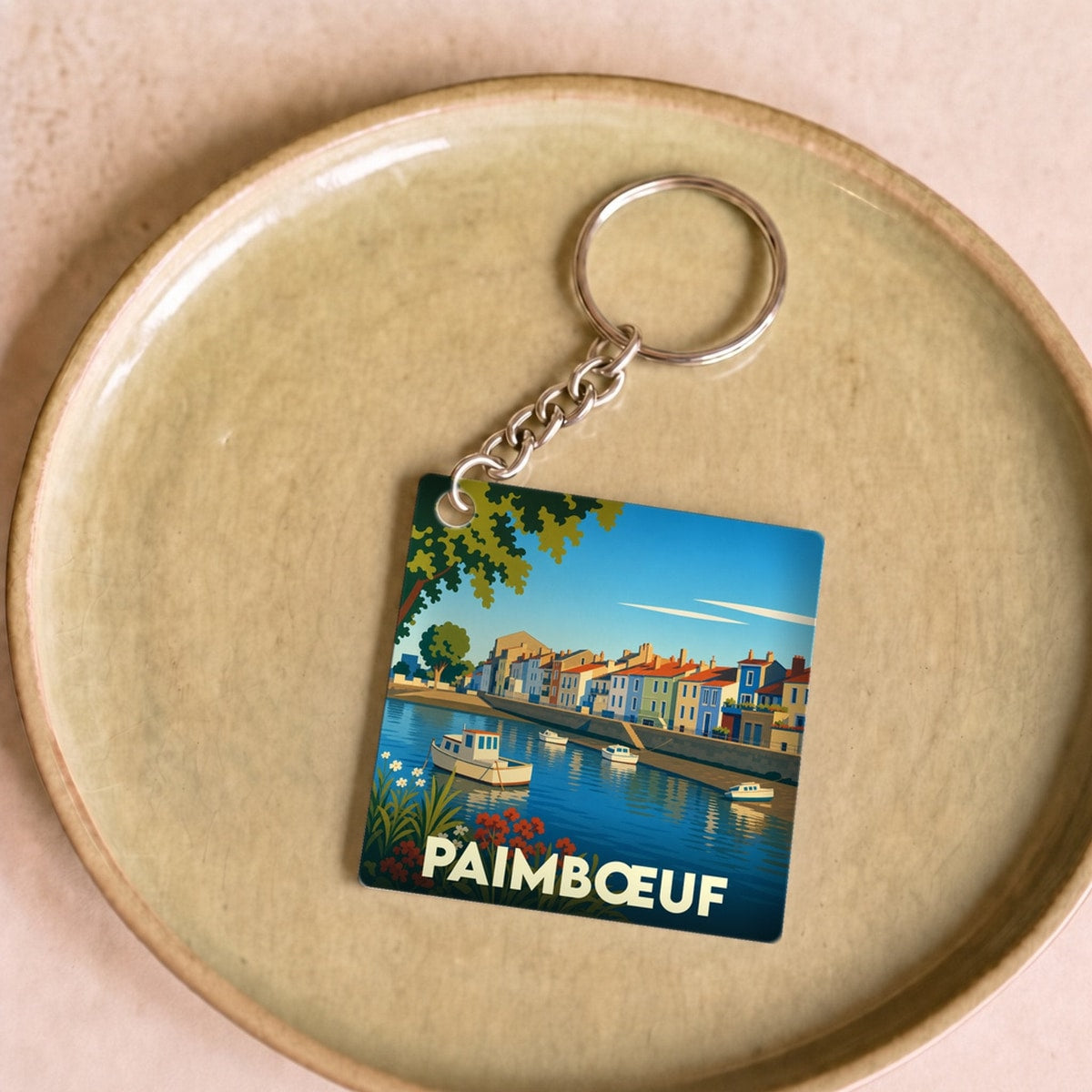 Porte-clés souvenir de la ville de Paimbœuf avec une illustration stylisée.