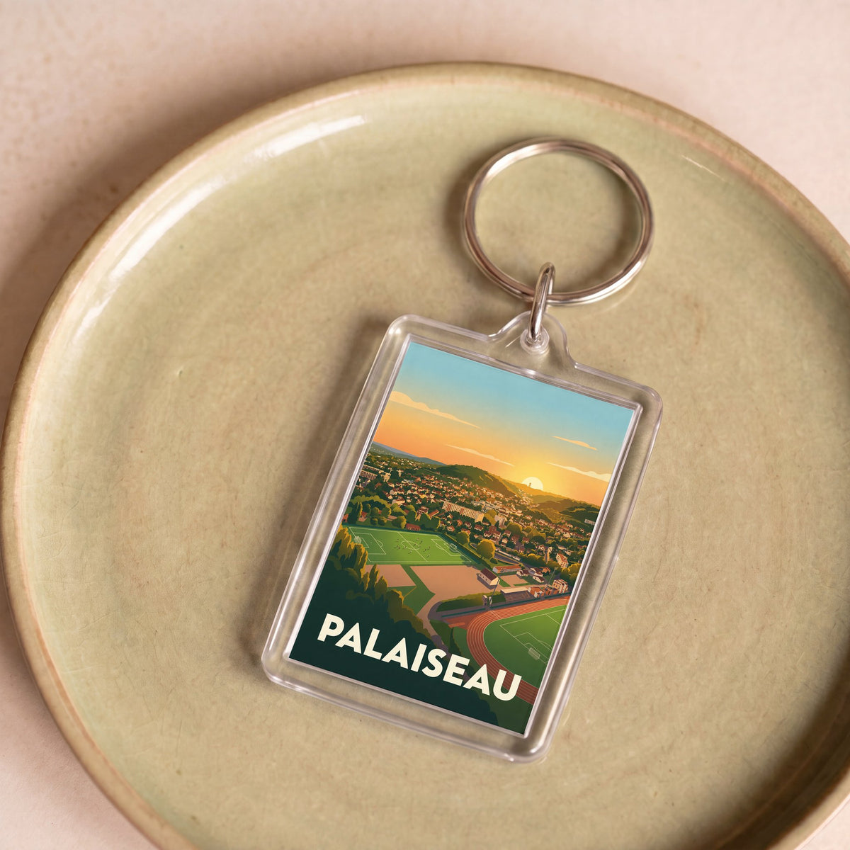 Porte-clés souvenir de la ville de Palaiseau orné d'une illustration stylisée de son paysage urbain.