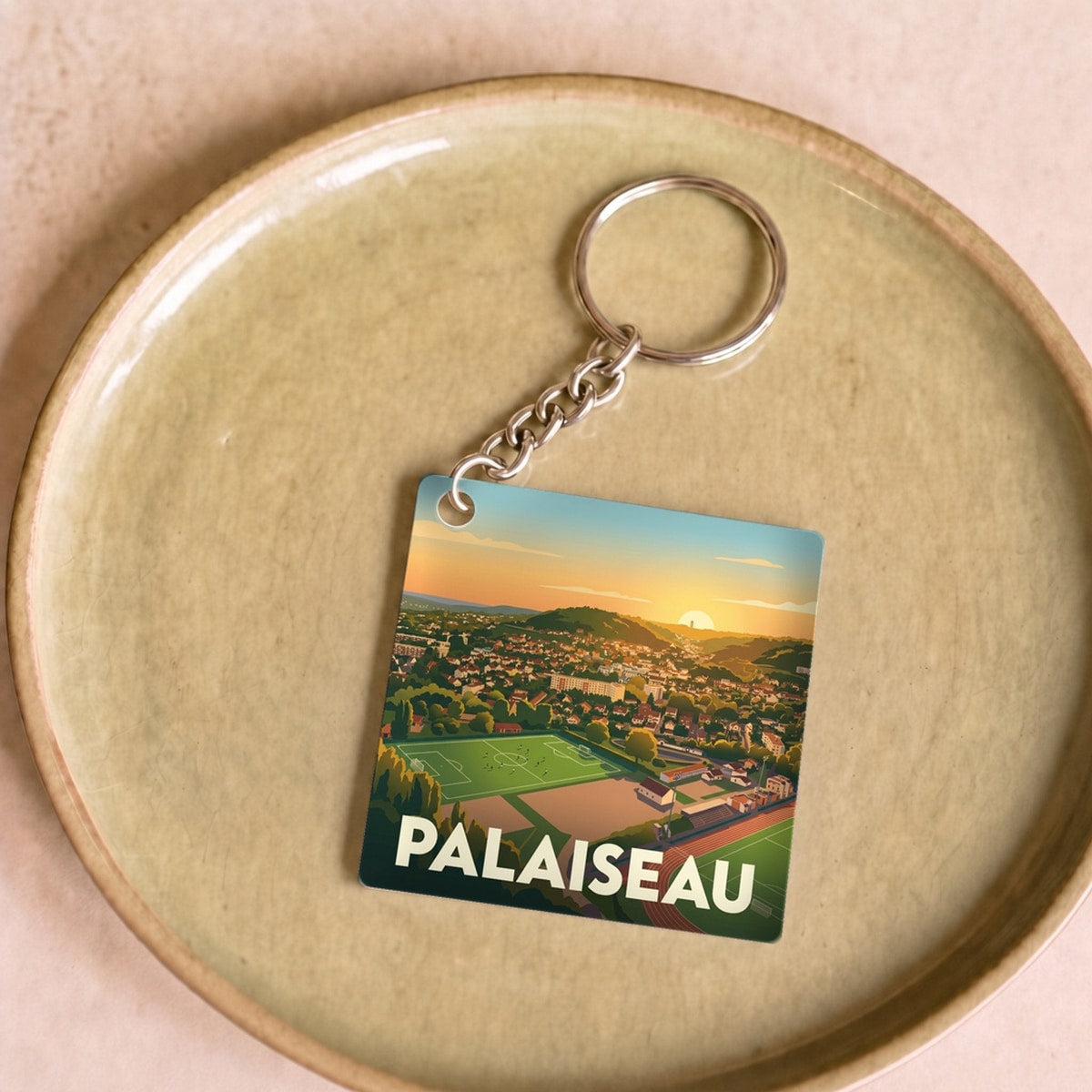 Porte-clés souvenir de la ville de Palaiseau orné d'une illustration stylisée de son paysage urbain.