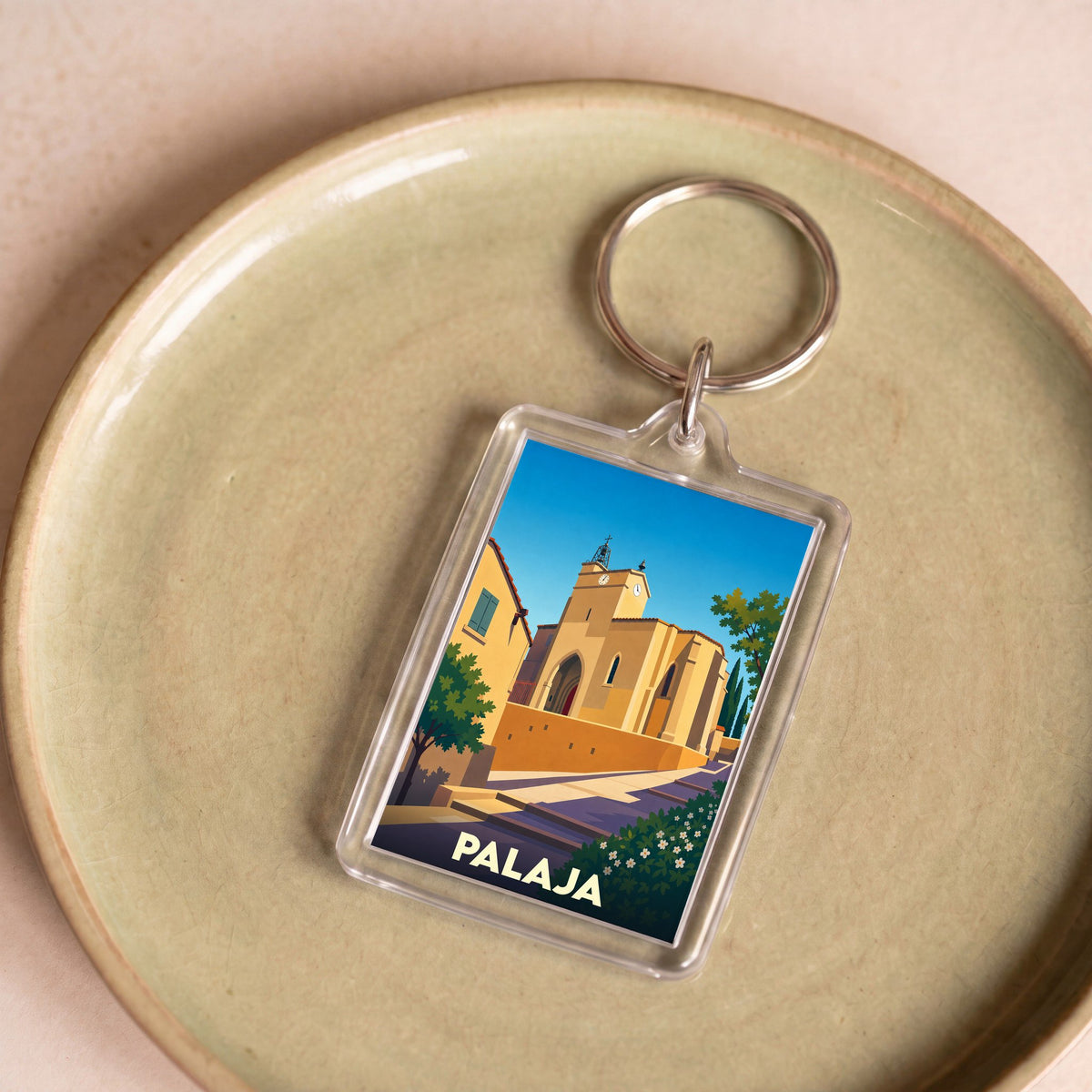 Porte-clés souvenir de la ville de Palaja avec une illustration stylisée de son église.